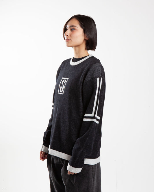 Black Stüssy sweater, side view, chest logo