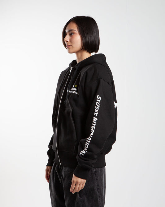 Black Stüssy zip-up hoodie, side view, with text on sleeves