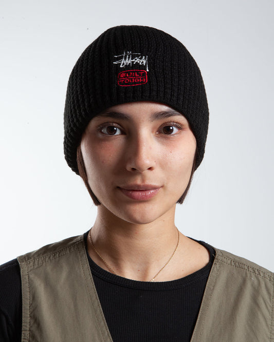 Black Stüssy beanie, front view, text detail