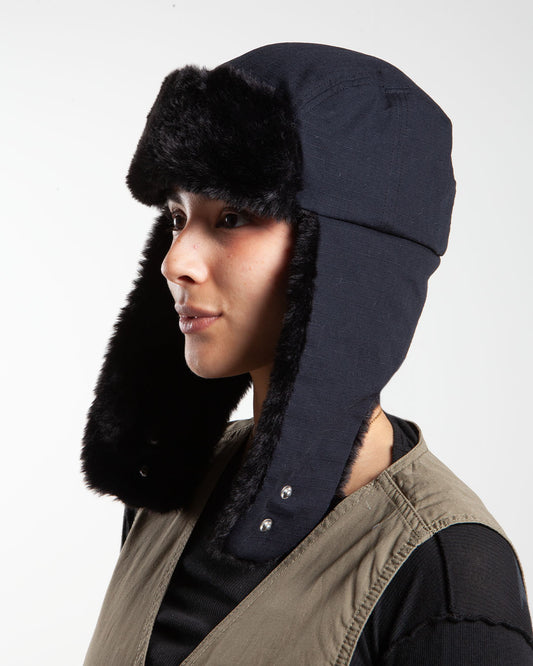 Black Stüssy trapper cap, side view