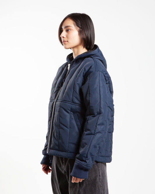 Navy Stüssy hood quilted jacket, side view
